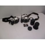 A pair of Canon EOs 60/60E cameras with mixed lenses