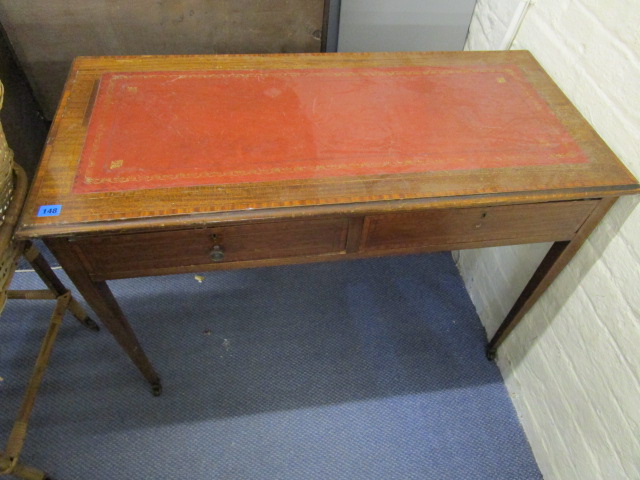 An Edwardian inlaid mahogany writing desk with a gilt tooled red leather scriber, two frieze drawers