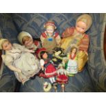 Two celluloid and cloth dolls and a selection of other 20th century dolls of the world