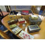 A mixed quantity of vintage tins in a leather suitcase, together with mixed boxed cards and