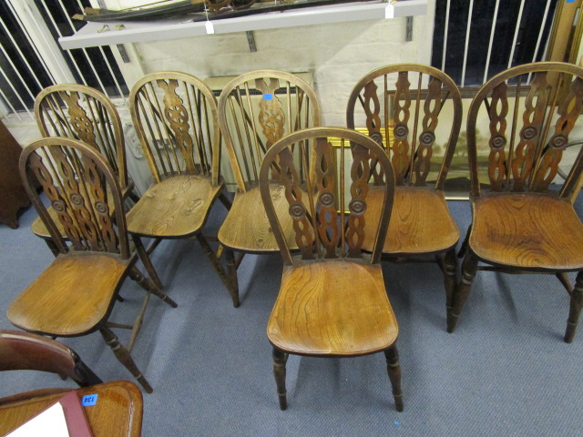 A set of four Windsor chairs, along with three Windsor wheel back chairs, early to mid 20th century