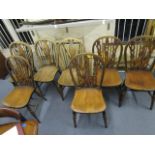 A set of four Windsor chairs, along with three Windsor wheel back chairs, early to mid 20th century