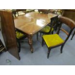 A Victorian mahogany extending dining table, standing on turned legs, (one extra leaf), along with a