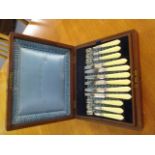 A mahogany cased Alex Clark & Co silver plated and simulated ivory handled fruit knives and forks