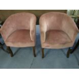 A pair of early 20th century pink dralon upholstered armchairs, raised on mahogany cabriole legs