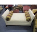 A modern chaise longue upholstered in a cream fabric, raised on square ebonized legs