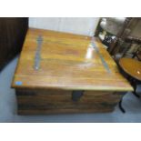 A modern teak chest having a twin, hinged, panelled top, raised on turned feet, 17 h x 36
