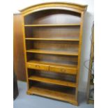 A modern bur elm bookcase with six shelves and two drawers, raised on bracket feet, 81h x 52w