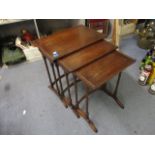 A nesting set of three mahogany occasional tables, raised on arched feet, the largest 23h x 21w