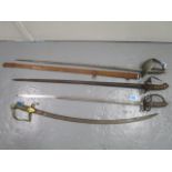 A group of four 19th century swords, one in a metal scabbard and another a cavalry sword with a