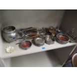 A mixed lot of silver plate to include flatware, wine coasters and a tripod based silver plated bowl