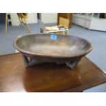 An early to mid 20th century carved treen African bowl supported by a nude female, 13 long