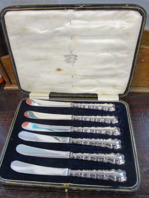 A set of six silver handled butter knives