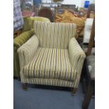 An early 20th century armchair upholstered in a striped fabric, raised on square tapered beech legs