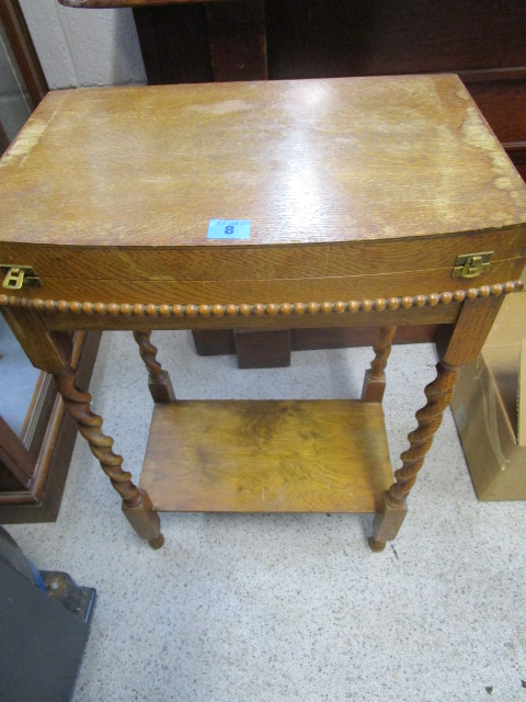 An early 20th century oak barley twist table canteen containing a Walker and Hall silver plated