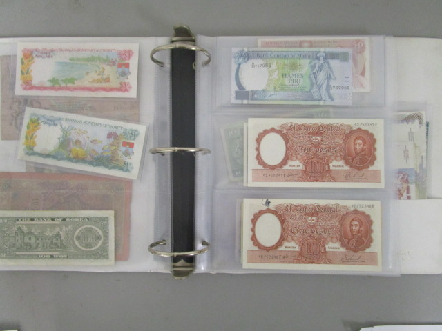 A folder of early to late 20th century banknotes to include a 1910 Russian 100 Roubles note, a
