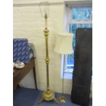A modern gilt wood standard lamp with a turned column, 58 h and a brass standard lamp