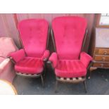 A pair of mid 20th century, dark Ercol stick back armchairs