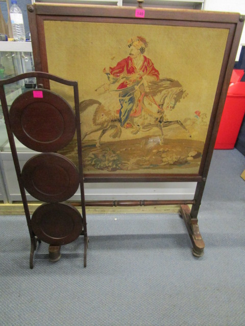 A Victorian rosewood framed and tapestry fire screen, the central panel depicting a horse and rider,