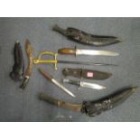 A group of Kukri daggers and other edged weaponry