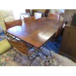 A custom made modern steel framed dining table with a planked, walnut top by The Charleston Forge