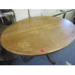 A 19th century walnut and mahogany oval snap top table