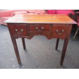 A Georgian mahogany lowboy having a moulded, rectangular top and three inset drawers, 27 3/4 h x