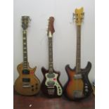 Three electric guitars, one a Hondo II, an Encore guitar, the last unmarked