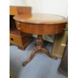 A reproduction carved, inlaid drum table on cabriole legs