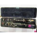 An early 20th century rosewood clarinet, the velvet lined interior of the case marked Maino &