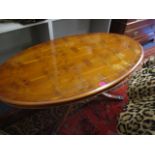 A reproduction yew, oval shaped coffee table, 21 h x 48.5 w