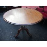 A Georgian mahogany tilt top occasional table having a circular top standing on three cabriole legs,