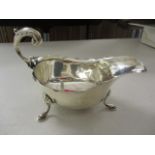 An early 20th century silver sauce boat on three splayed legs, hallmarked Birmingham 1932