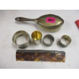 German silver and white metal to include three napkin rings, a hair brush, a comb and a cup