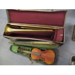 An early 20th century violin and bow, unmarked, 22 long, cased and a continental brass trombone with