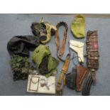 A selection of military equipment to include a leather ammunition belt, leather and canvas pistol