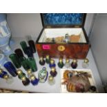 A Victorian walnut box containing various scent bottles, clear, blue, green and amber scent