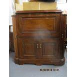 A Chinese brass inlaid exotic hardwood drinks cabinet with a hinged top and front, over a pair of