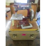 A vintage 1950s travelling sewing machine in a case