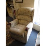 A late 20th century wingback armchair with beige floral upholstery