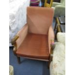 A mid 20th century mahogany framed armchair with rams mask handles, upholstered in pink dralon