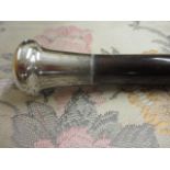 A silver topped walking cane