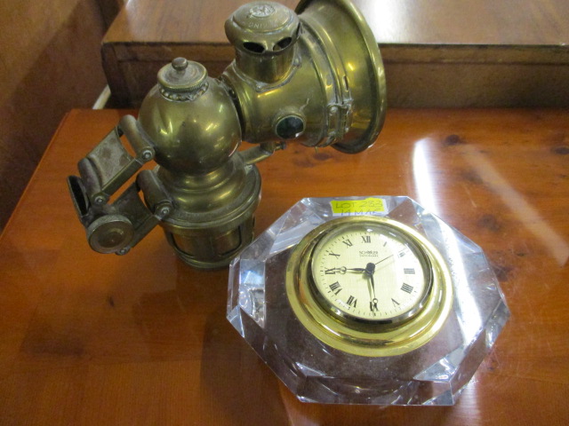 A Lucas King of the Road car/motorcycle acetylene lamp and a Scoler table top clock mounted within a