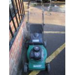 A Qualcast Briggs and Stratton 450 series 148cc garden petrol lawn mower with grass basket