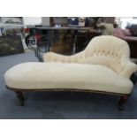 A late Victorian, walnut framed chaise longue with cream button back upholstery, on short