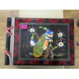 An oriental lacquered and painted musical photograph album, the front decorated with applied stone