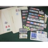 A quantity of world stamps mounted on paper, some loose with a couple of 1st day covers and a