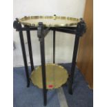 An early to mid 20th century Chinese folding tray table with two brass trays on an ebonized stand