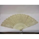 A 19th century French fan with pierced bone sticks, lace leaf and the guards are inlaid with steel