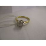 An 18ct gold and platinum solitaire diamond ring in an illusion setting, approximately 0.6ct